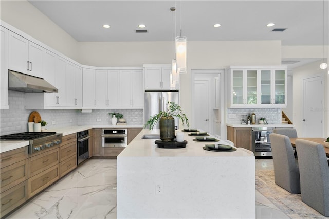 kitchen with wine cooler, appliances with stainless steel finishes, a center island, under cabinet range hood, and marble finish floor