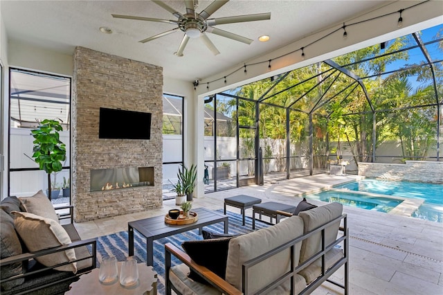 exterior space with a fenced backyard, an outdoor living space with a fireplace, a lanai, and ceiling fan