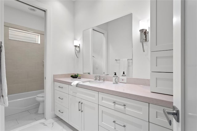 full bath with marble finish floor, toilet, vanity, and washtub / shower combination