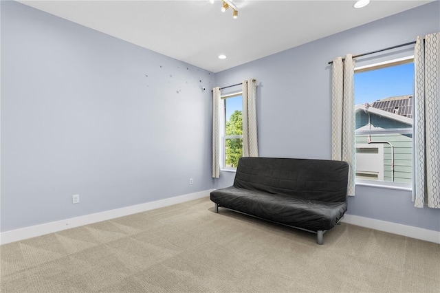 sitting room with baseboards, recessed lighting, and carpet