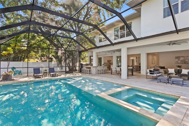 view of swimming pool featuring outdoor dry bar, glass enclosure, outdoor lounge area, and a patio area