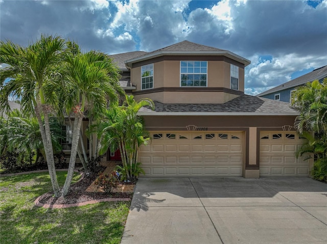 view of front facade featuring concrete driveway, stucco siding, a garage, and a shingled roof