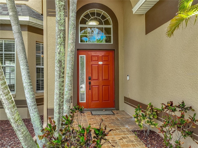 property entrance with stucco siding