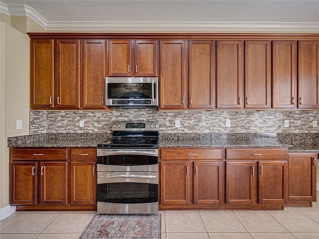 kitchen featuring dark stone countertops, decorative backsplash, and stainless steel appliances
