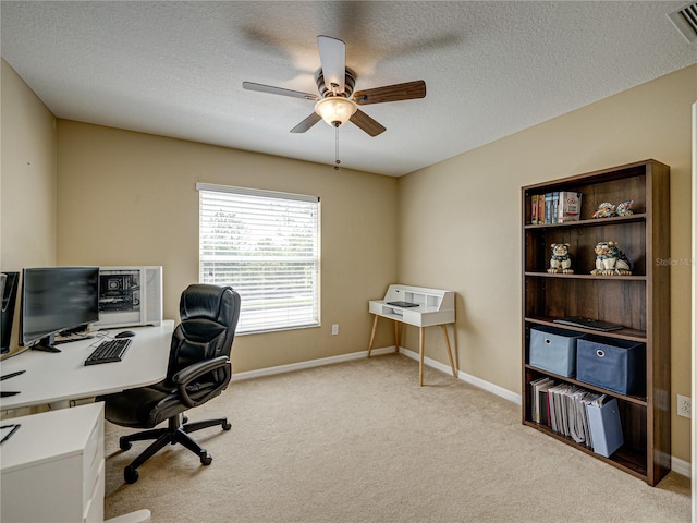 home office featuring a textured ceiling, ceiling fan, baseboards, and carpet floors