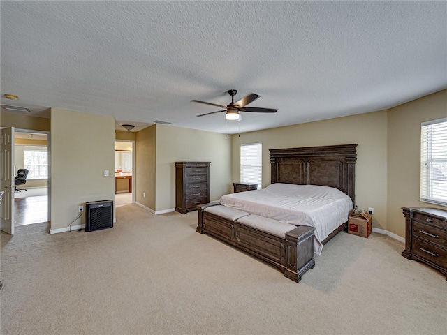 bedroom with light colored carpet, multiple windows, and visible vents