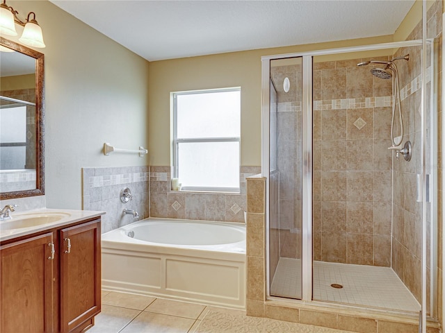 full bath with a bath, tile patterned floors, vanity, and a stall shower