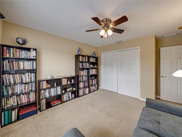 sitting room featuring carpet floors, ceiling fan, visible vents, and baseboards