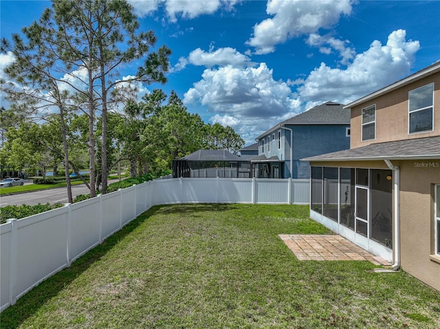 view of yard with a fenced backyard and a sunroom