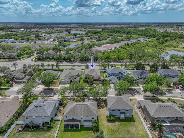 birds eye view of property featuring a water view and a residential view