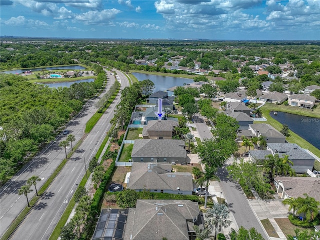 birds eye view of property with a water view and a residential view