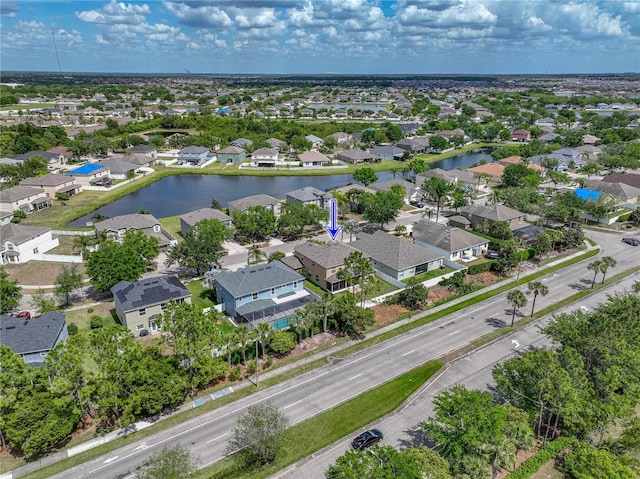birds eye view of property with a water view and a residential view