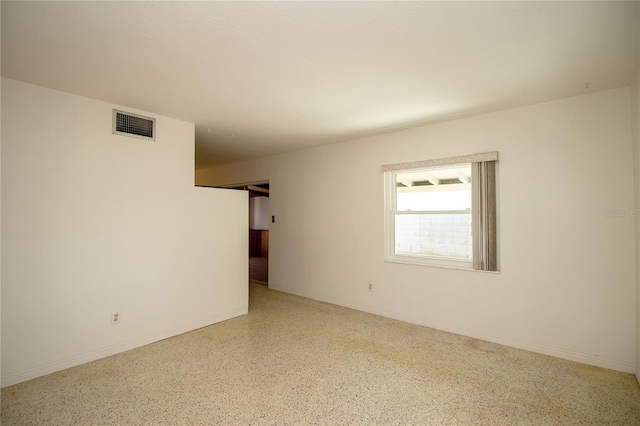 721 75th Ave N, Saint Petersburg, FL 33702 - unfurnished room featuring visible vents, baseboards, and speckled floor
