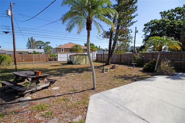 721 75th Ave N, Saint Petersburg, FL 33702 - view of yard with a fenced backyard, an outdoor structure, and a storage unit