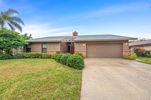 single story home with driveway, a garage, a front yard, and brick siding