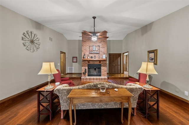 living area featuring visible vents, ceiling fan, wood finished floors, and a fireplace