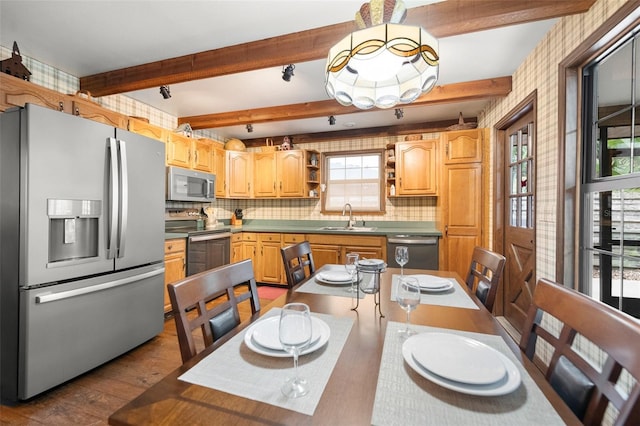 dining room with beam ceiling and dark wood finished floors