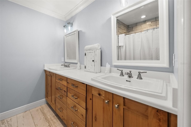 bathroom featuring double vanity, baseboards, a sink, and ornamental molding