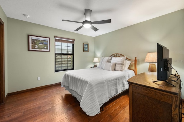 bedroom with dark wood-style flooring, baseboards, and a ceiling fan