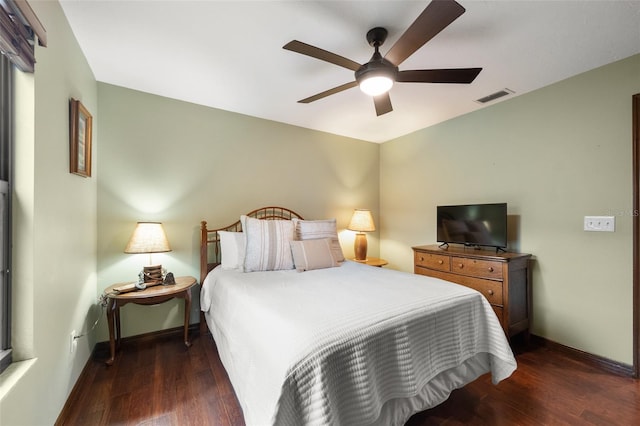 bedroom featuring visible vents, baseboards, a ceiling fan, and wood finished floors