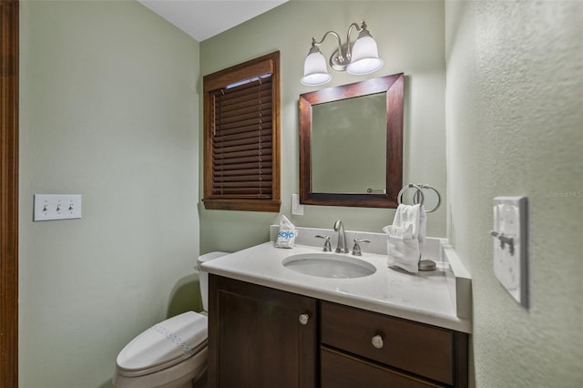 bathroom featuring toilet and vanity