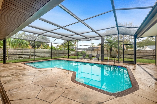 view of pool featuring a fenced in pool, a patio area, a fenced backyard, and glass enclosure