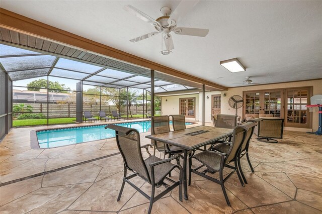view of swimming pool with a fenced in pool, a patio, french doors, a ceiling fan, and glass enclosure
