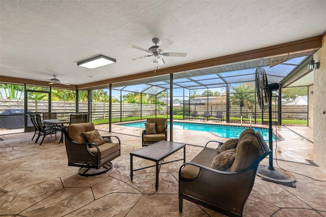 view of patio featuring a lanai, a fenced backyard, and a ceiling fan