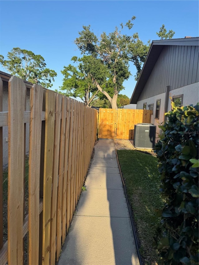 view of yard featuring cooling unit and fence