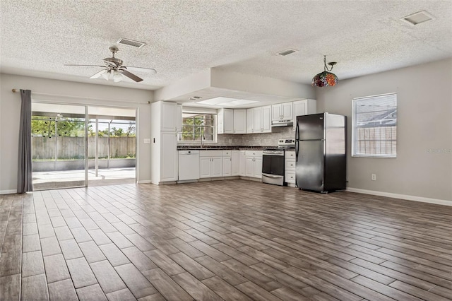14013 Briardale Ln, Tampa, FL 33618 - interior space featuring baseboards, freestanding refrigerator, stainless steel range with electric cooktop, ceiling fan, and dishwasher