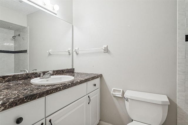 14013 Briardale Ln, Tampa, FL 33618 - bathroom featuring a tile shower, toilet, and vanity