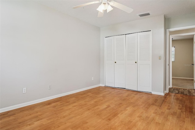14013 Briardale Ln, Tampa, FL 33618 - unfurnished bedroom with a closet, light wood-type flooring, baseboards, visible vents, and ceiling fan