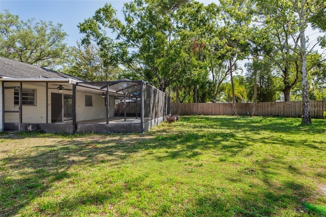 14013 Briardale Ln, Tampa, FL 33618 - view of yard featuring ceiling fan, a fenced backyard, a patio area, and glass enclosure