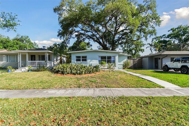 ranch-style house featuring a front yard and covered porch