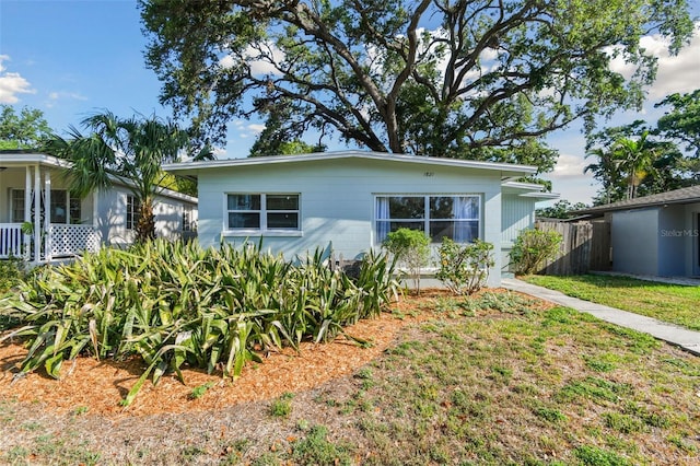 view of front of property with a front yard and fence