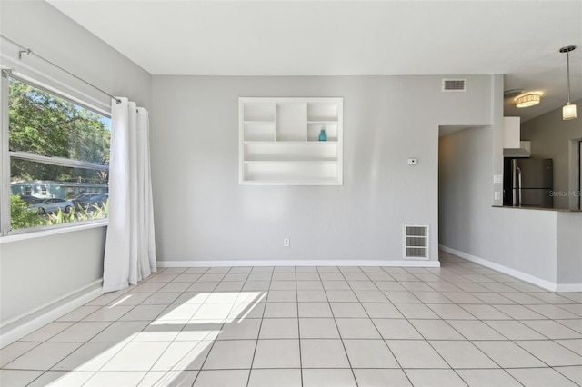 spare room with visible vents, built in features, light tile patterned flooring, and baseboards