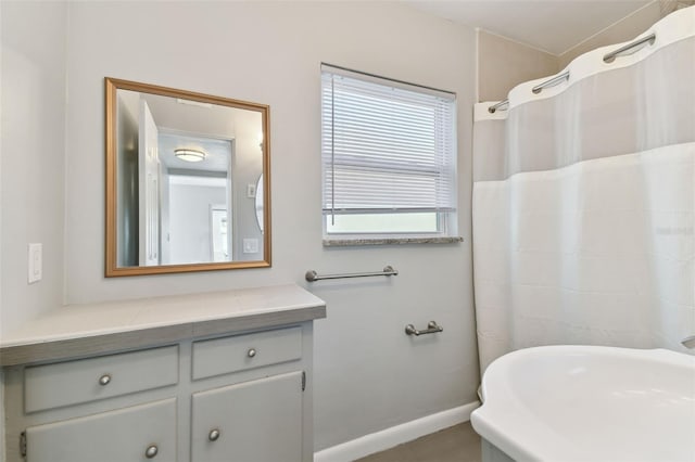 bathroom featuring baseboards, vanity, and a shower with curtain