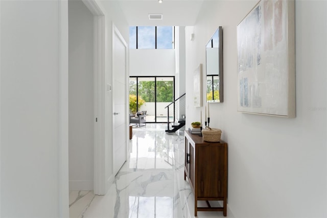 7608 Antilla St, Tampa, FL 33625 - corridor with marble finish floor, visible vents, and a towering ceiling