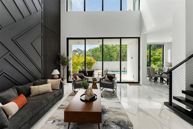 7608 Antilla St, Tampa, FL 33625 - living room with marble finish floor, a towering ceiling, and stairs