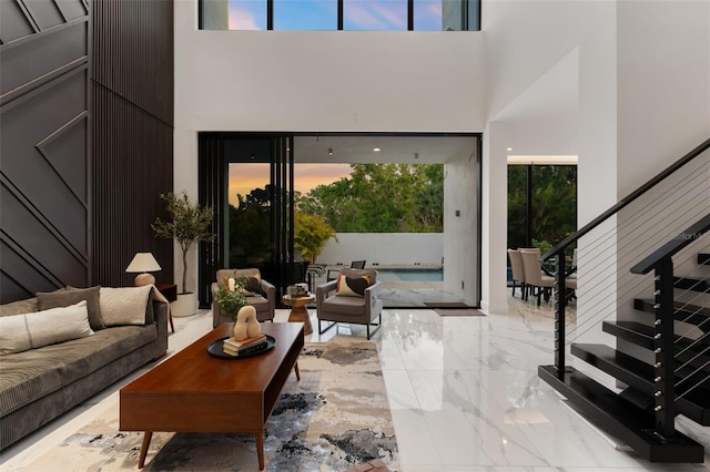 7608 Antilla St, Tampa, FL 33625 - living room featuring marble finish floor, a towering ceiling, and stairway