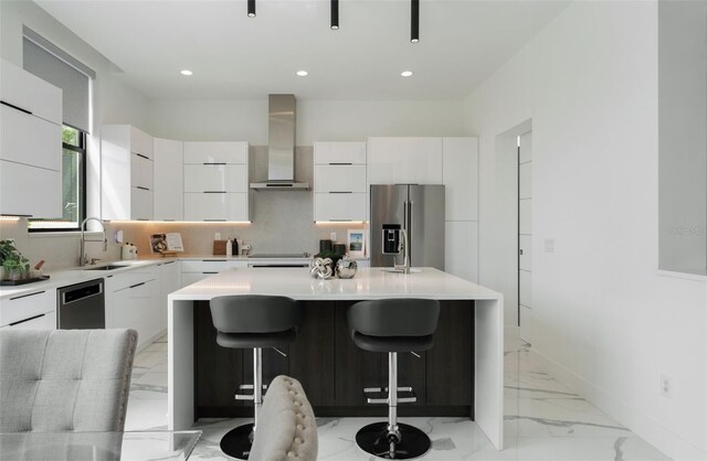 7608 Antilla St, Tampa, FL 33625 - kitchen with tasteful backsplash, white cabinets, modern cabinets, appliances with stainless steel finishes, and wall chimney exhaust hood