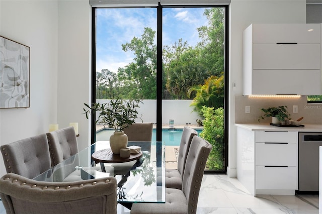 7608 Antilla St, Tampa, FL 33625 - dining area with marble finish floor, a wealth of natural light, and floor to ceiling windows