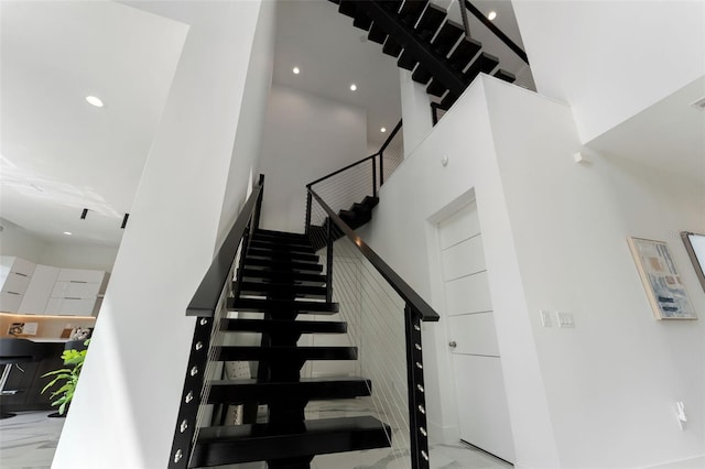 7608 Antilla St, Tampa, FL 33625 - stairs featuring marble finish floor, a high ceiling, and recessed lighting