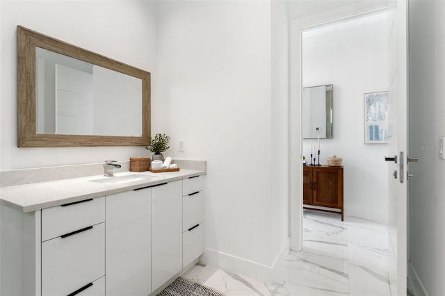 7608 Antilla St, Tampa, FL 33625 - bathroom with baseboards, marble finish floor, and vanity
