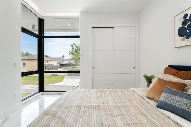 7608 Antilla St, Tampa, FL 33625 - bedroom with marble finish floor, baseboards, and floor to ceiling windows