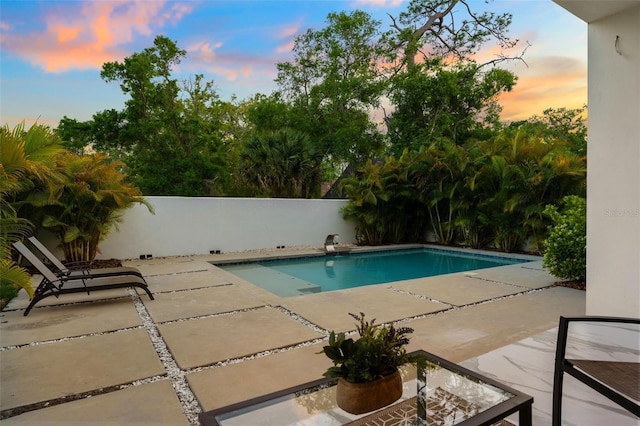 7608 Antilla St, Tampa, FL 33625 - pool at dusk featuring fence, a patio, and a fenced in pool