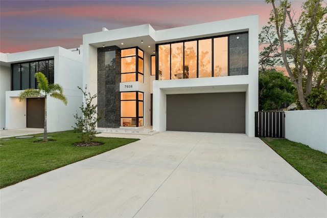 7608 Antilla St, Tampa, FL 33625 - contemporary home with a lawn, stucco siding, an attached garage, and concrete driveway