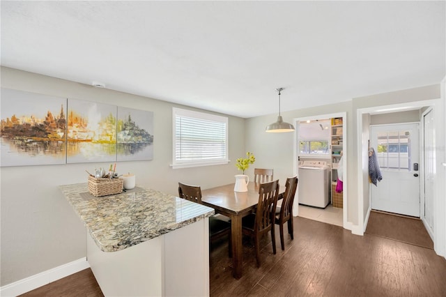 5367 5th Ave N, Saint Petersburg, FL 33710 - dining area with baseboards, dark wood-style flooring, and separate washer and dryer