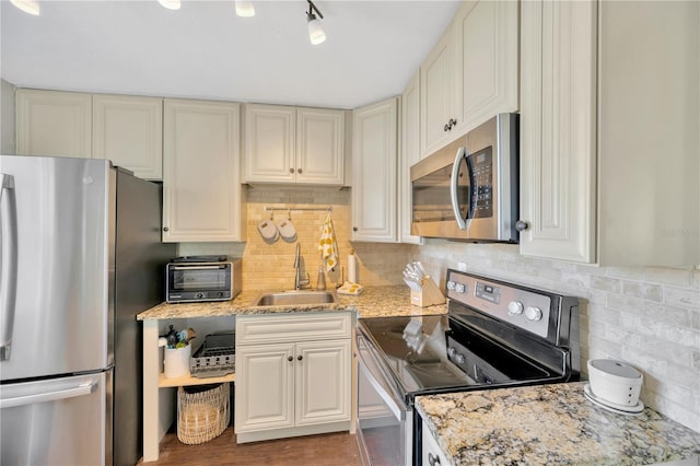 5367 5th Ave N, Saint Petersburg, FL 33710 - kitchen featuring stainless steel appliances, a toaster, backsplash, a sink, and light stone counters