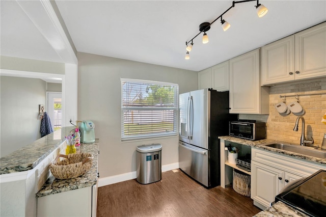 5367 5th Ave N, Saint Petersburg, FL 33710 - kitchen with a sink, tasteful backsplash, a peninsula, stainless steel refrigerator with ice dispenser, and dark wood-type flooring